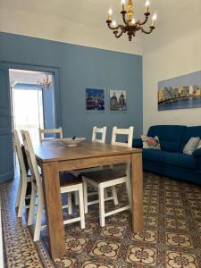 a dining room with a wooden table and chairs at Annacare in Trapani