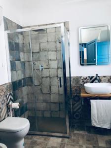 a bathroom with a shower and a toilet and a sink at Annacare in Trapani