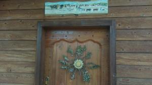 a wooden door with a christmas wreath on it at La Carline in Guillestre