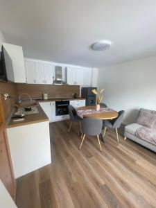 a kitchen and living room with a table and chairs at Апартамент ФЕРДИНАНД in Ruse