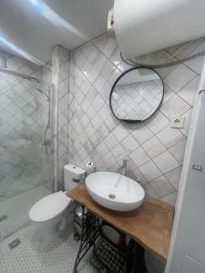 a bathroom with a toilet and a sink and a mirror at Апартамент ФЕРДИНАНД in Ruse +21 photos
