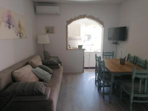 a living room with a couch and a table at Apartment Medulin in Medulin