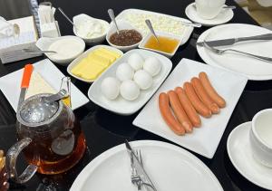 a table topped with plates of food with eggs and carrots at Imperial Hotel in Kapan