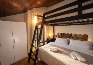 a bedroom with a bunk bed with a ladder at Villa Pineta Grande in Lignano Sabbiadoro