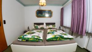 a bedroom with a bed with two pillows at Ferienwohnungen Anders in Braunlage