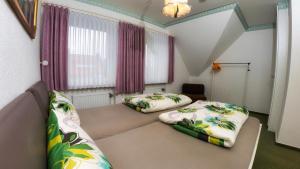 a small room with two beds in a room at Ferienwohnungen Anders in Braunlage +16 photos