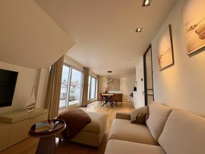 a living room with a couch and a table at Maison Elouise in Middelkerke