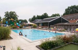 a group of people in a swimming pool at Vakantiehuisje op 5 star kindercamping in Mariënberg
