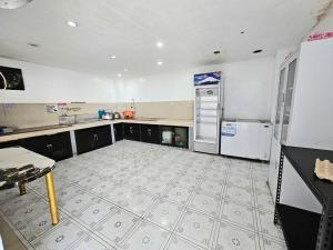 an empty kitchen with a stove and a refrigerator at Crestscente Skye Villa Resort in Pañgil