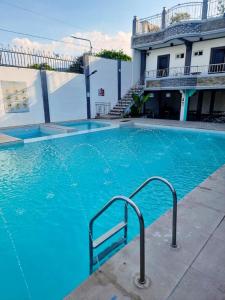 a large blue swimming pool in front of a building at Crestscente Skye Villa Resort in Pañgil