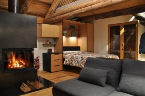 a bedroom with a bed and a fireplace at Rustico La Stalla a Pianezza in Menzonio