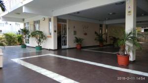 a lobby with potted plants in a building at Studio without kitchen at Alpha Villa in Flic-en-Flac
