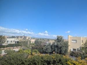 a view of a city with buildings and trees at הבית הכחול in Haspin