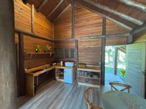 a kitchen with wooden walls and wooden floors at refugio in Aguas Mornas