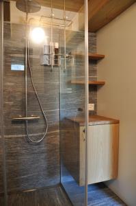 a bathroom with a shower with a glass door at Rustico La Stalla a Pianezza in Menzonio