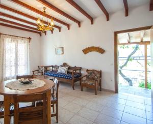 a living room with a table and chairs at Angela studios in Troulos