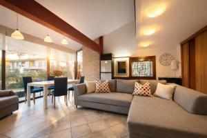 a living room with a couch and a table at Villa Pineta Grande in Lignano Sabbiadoro