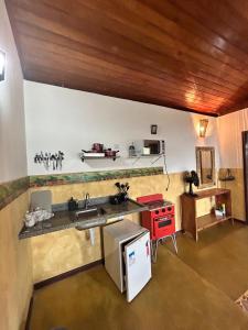 a kitchen with a sink and a counter top at Chalés Lavras de Minas - Canadá in Lavras Novas +26 photos