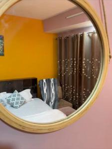 a mirror with a chair in a room at Qeva Apartment I in Kathmandu