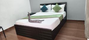 a bedroom with two beds with a cat on the bed at Elevate 1478 Inn in Nandigunda