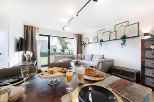 a living room with a table with food on it at Burgberg City Apartment in Daun