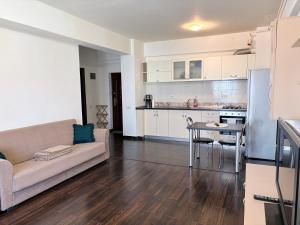 a living room with a couch and a table at Bella Home Residence2 in Roşu