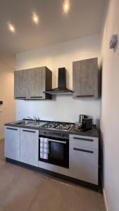 a kitchen with a stove and a stove top oven at CR Home in Palermo +9 photos