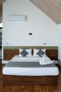a bedroom with a large bed with a wooden headboard at VerdEra Wild - Wilpattu in Wilpattu