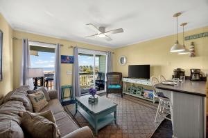 a living room with a couch and a table at SC304A: 304A Sea Cabin in Isle of Palms