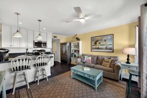 a living room with a couch and a kitchen at SC304A: 304A Sea Cabin in Isle of Palms