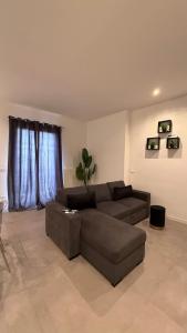 a living room with a brown couch and a table at CR Home in Palermo