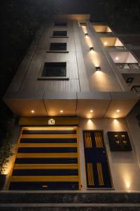 a building with its doors lit up at night at Suitcase Stories Delhi in New Delhi