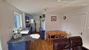 a kitchen and dining room with a table and chairs at Sea Drift Self Catering in Dunan +17 photos
