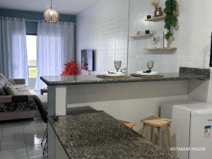 a kitchen with a counter top in a room at Villagio Vistamar Ilha Comprida in Ilha Comprida