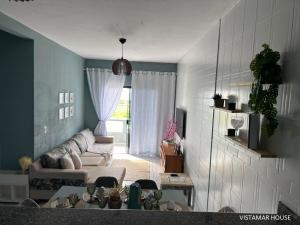 a living room with a couch and a table at Villagio Vistamar Ilha Comprida in Ilha Comprida