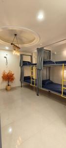 a dorm room with three bunk beds in it at Suitcase Stories Delhi in New Delhi