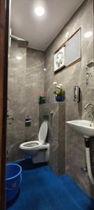 a bathroom with a toilet and a sink at Suitcase Stories Delhi in New Delhi +43 photos
