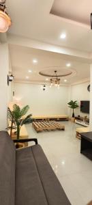 a living room with a couch and a table at Suitcase Stories Delhi in New Delhi