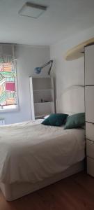 a bedroom with a white bed and a window at Sabino Arana 9, habitación doble con servicios compartidos in Lekeitio