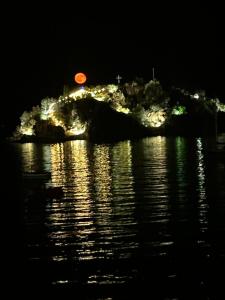 an island in the middle of the water at night at Tolo in Tolo