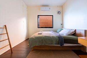 a small bedroom with a bed and a window at Searyn Lanta in Ko Lanta