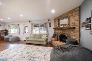 a living room with a couch and a fireplace at ArtLens Casa in Schertz