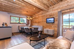 a living room with a couch and a table at Hauserhof- Urlaub am Bauernhof inklusive Sommercard in Bramberg am Wildkogel