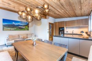 a kitchen and dining room with a wooden ceiling at Hauserhof- Urlaub am Bauernhof inklusive Sommercard in Bramberg am Wildkogel