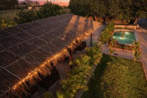 an overhead view of a pool with palm trees and lights at Achal Bagh - Boutique Stay Abu Road in Māwāl