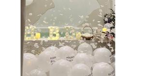 a bunch of white balloons in front of a party at 24Rooms นครสวรรค์ in Nakhon Sawan