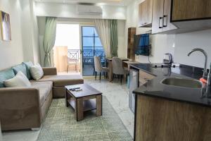a kitchen and living room with a couch and a table at Juliana Beach Hurghada in Hurghada