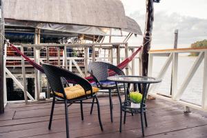 three chairs and a table on a boat at Searyn Lanta in Ko Lanta