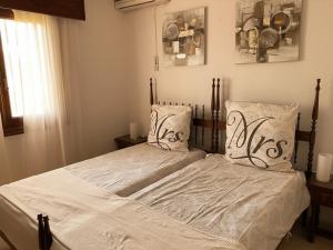 a bedroom with a bed with white sheets and pillows at Luxuriöses Chalet mit privatem Pool in Roquetas de Mar