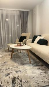 a living room with a couch and a coffee table at Апартамент Зора in Chepelare